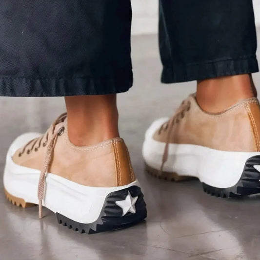 View of women's chic sneakers in soft gray fabric with cushioned sole and stylish lace up design