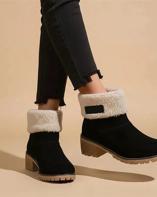 View of stylish women's ankle boots in brown suede, featuring a chunky heel and elastic panels