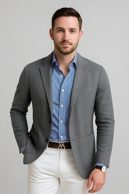 View of a polished relaxed blazer in dark gray, featuring a smooth fabric texture and tailored lapels