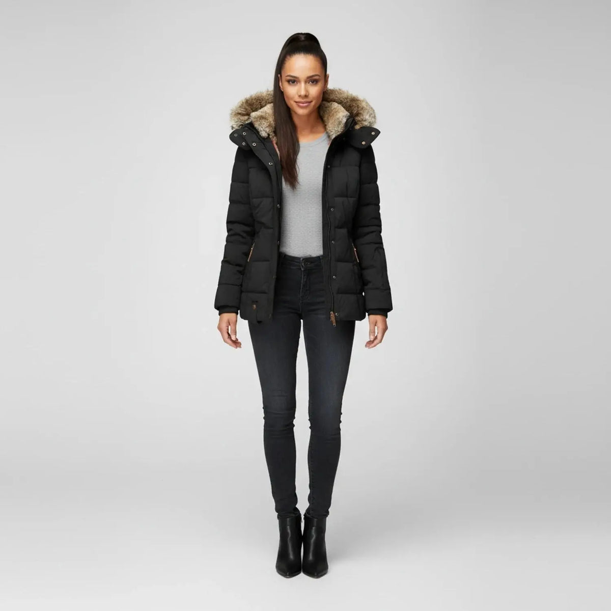 View of a fitted winter puffer jacket in deep green, featuring a high collar and sleek silhouette