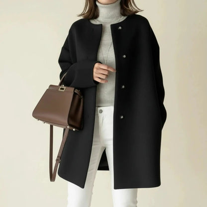 View of a charcoal gray winter coat with a minimalist design, featuring a sleek silhouette and button closure