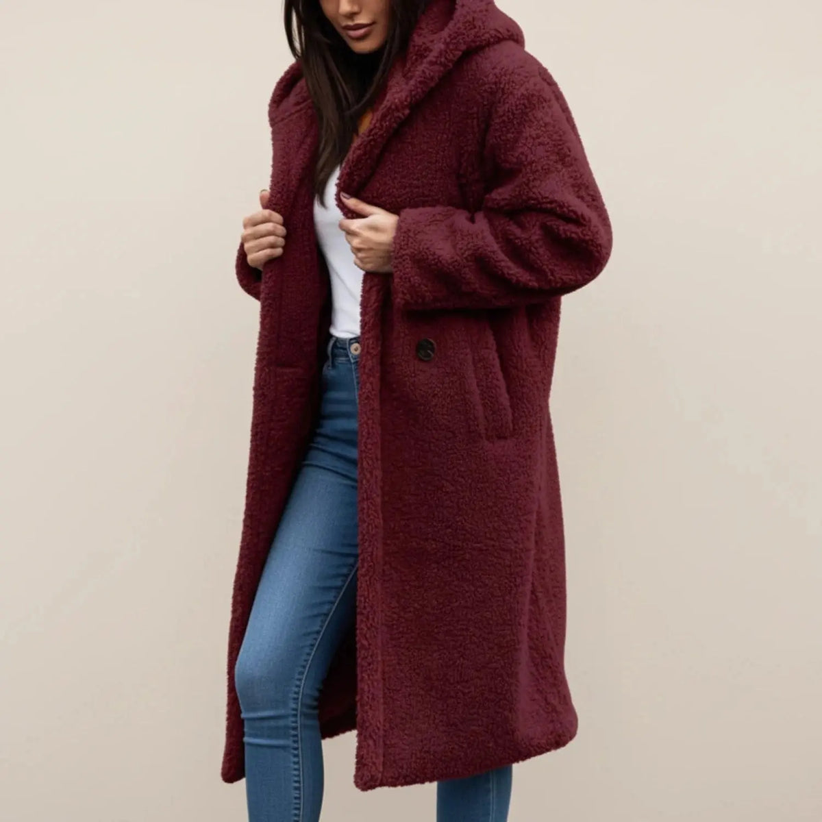 View of a cozy winter coat in soft gray fabric, featuring a relaxed fit, large pockets, and a high collar