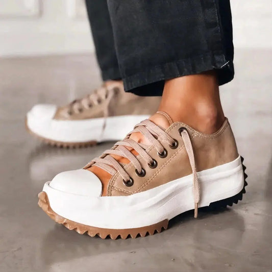 View of women's chic sneakers in light gray mesh with white rubber soles and stylish lace up design