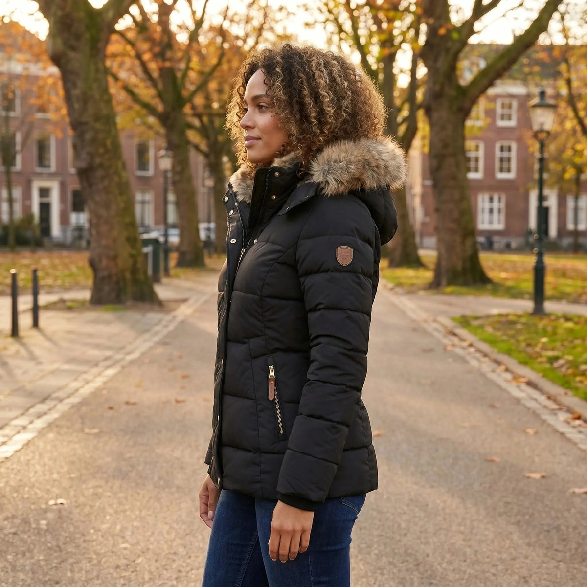 View of a fitted winter puffer jacket in deep burgundy, featuring a high collar and quilted texture