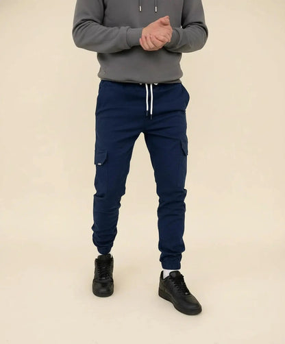 View of modern slim tapered cargo pants in olive green, featuring multiple pockets and a soft cotton blend fabric