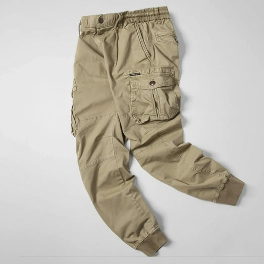 View of relaxed utility summer cargo jogger pants in light khaki, featuring multiple pockets and a comfortable fit