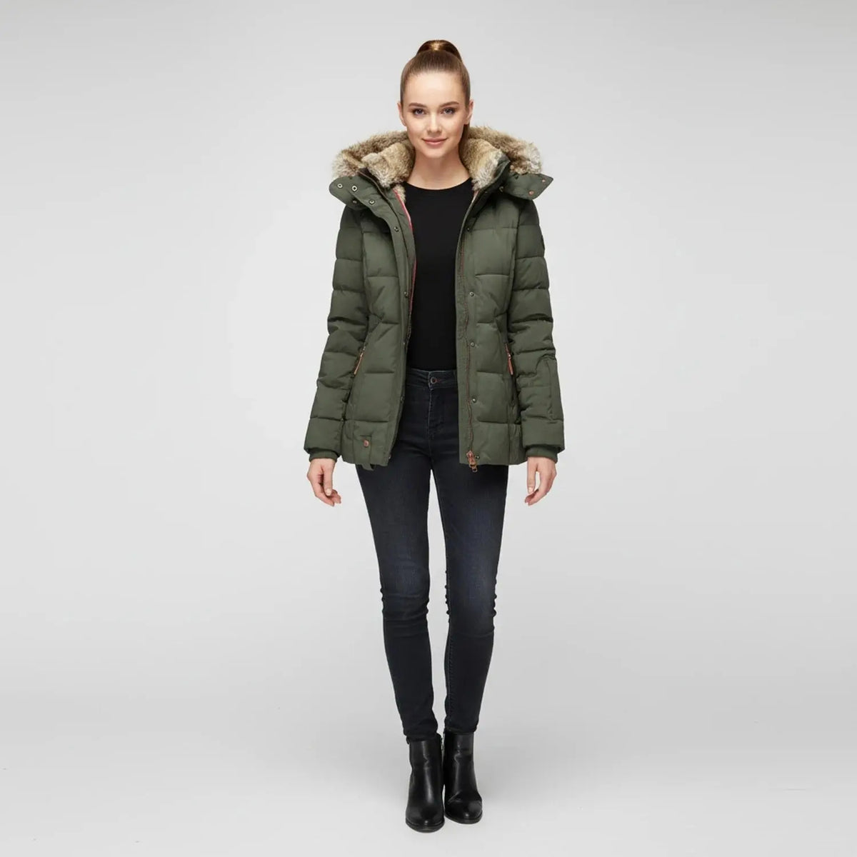 View of a fitted winter puffer jacket in deep green, featuring a high collar and quilted texture