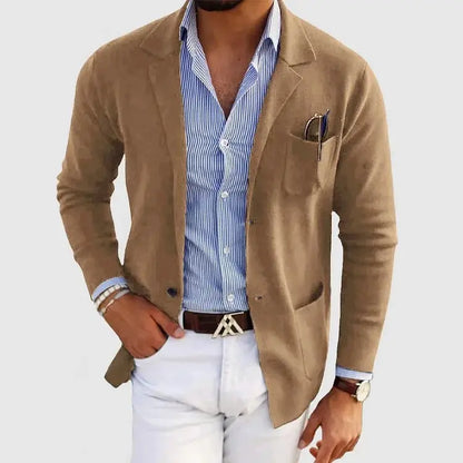 View of a polished relaxed blazer in a deep charcoal gray, featuring a single button closure and notch lapels