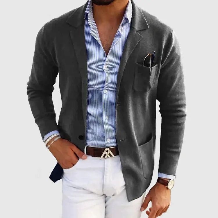 View of a polished relaxed blazer in dark gray, featuring notched lapels and a single button closure