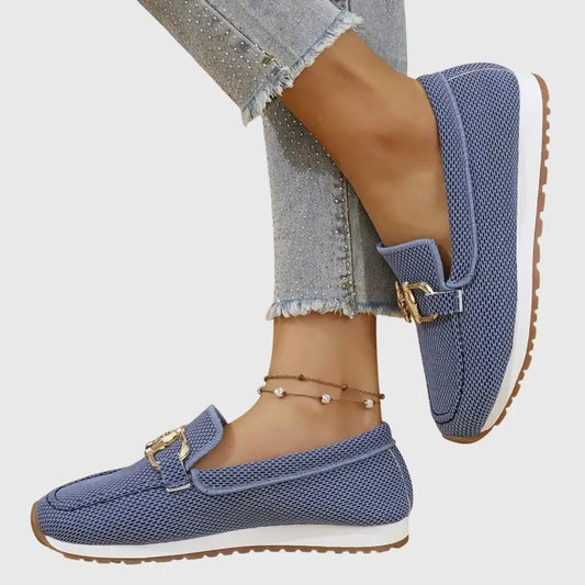 View of chic women's slip on loafers in soft beige leather with a sleek silhouette and cushioned insole
