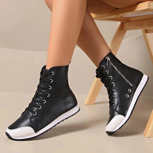 View of women's chic supportive sneakers in light gray mesh with white soles and cushioned ankle support