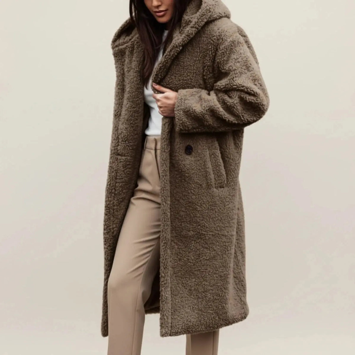 View of a cozy relaxed winter coat in soft gray fabric, featuring a hood and button closure