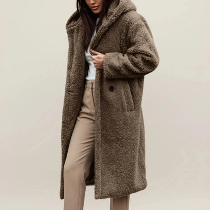 View of a cozy relaxed winter coat in soft gray fabric, featuring a hood and button closure