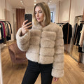 View of a luxurious fluffy autumn coat in soft beige, featuring a cozy collar and button closure
