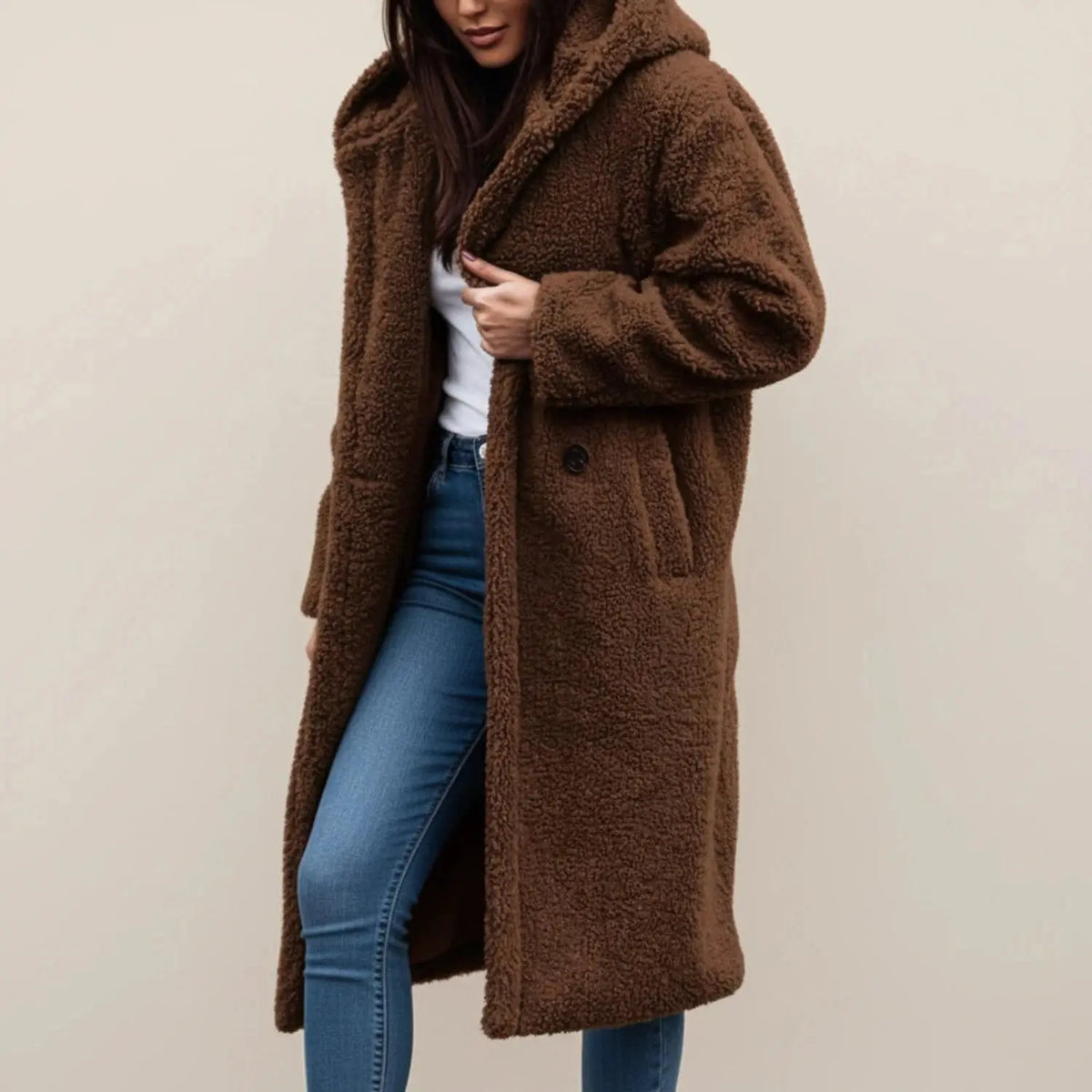 View of a cozy relaxed winter coat in soft gray fabric, featuring a hood and button closure