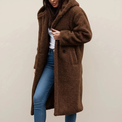 View of a cozy relaxed winter coat in soft gray fabric, featuring a hood and button closure