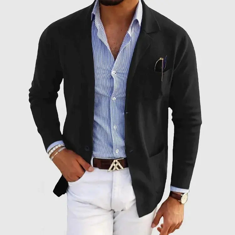 View of a polished relaxed blazer in a deep charcoal gray, featuring a smooth fabric texture and subtle lapel design