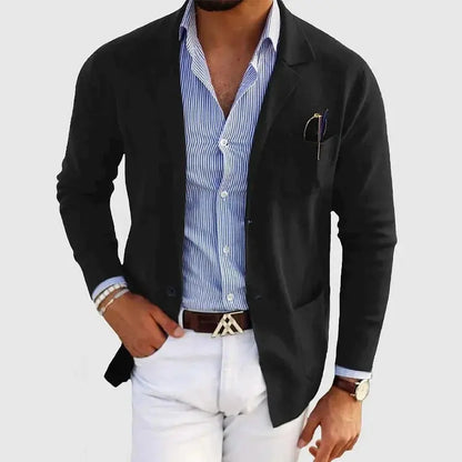 View of a polished relaxed blazer in a deep charcoal gray, featuring a smooth fabric texture and subtle lapel design