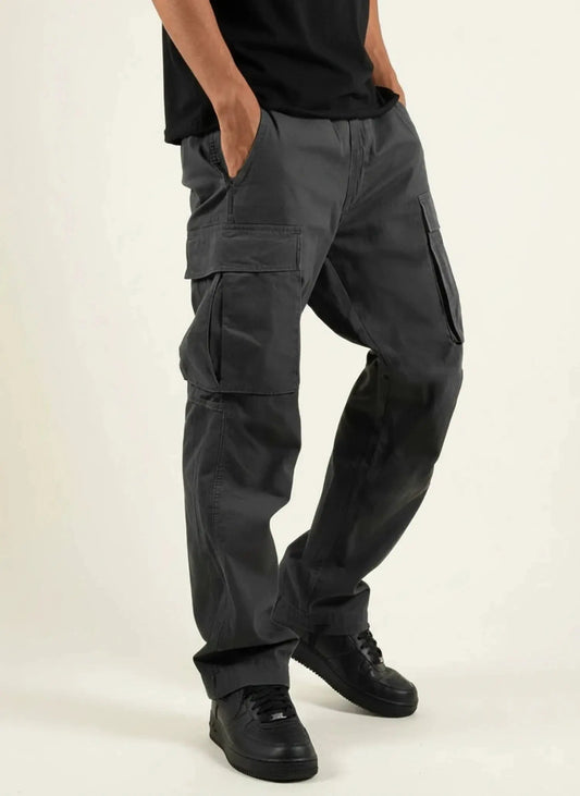 View of relaxed fit cargo pants in olive green, featuring multiple pockets and a comfortable waistband