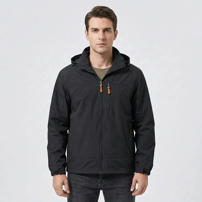 View of a water repellent outdoor jacket in dark green, featuring a high collar and zippered pockets