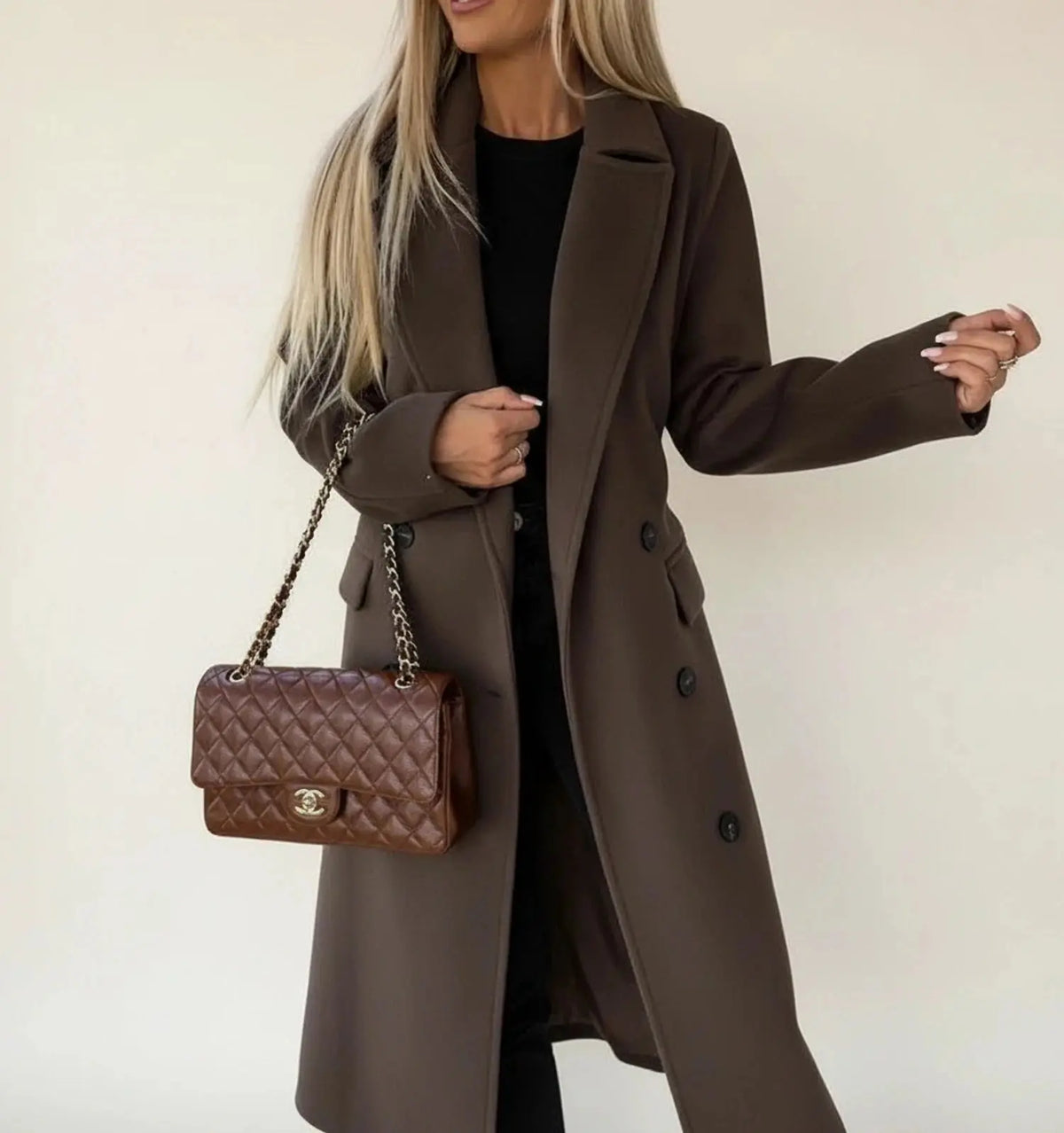 View of a sophisticated women's winter overcoat in deep burgundy, featuring a tailored fit and elegant collar