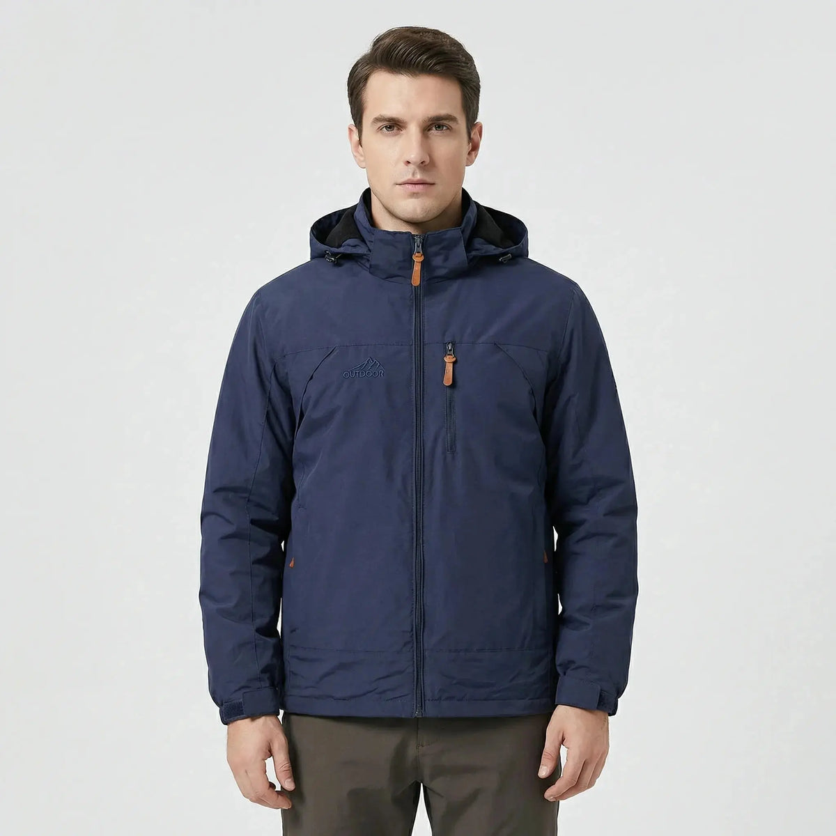 View of a water repellent outdoor jacket in dark green, featuring a high collar and zippered pockets