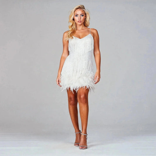Woman wearing white fringe V neck midi dress with feathered hem, standing with hands