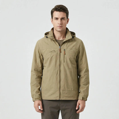 View of a water repellent outdoor jacket in dark green, featuring a high collar and zippered pockets