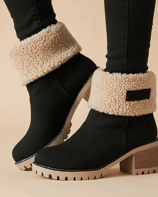 View of stylish women's ankle boots in rich brown leather, featuring a rounded toe and decorative stitching