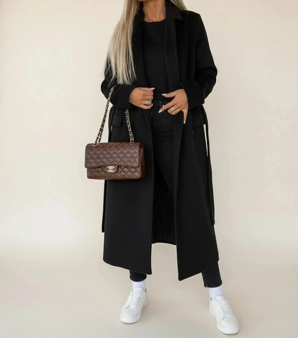 View of a sophisticated women's winter overcoat in deep burgundy, featuring a tailored silhouette and elegant lapels