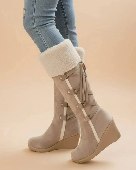 View of elegant women's winter boots in soft gray suede, featuring a cozy faux fur lining and sturdy rubber sole