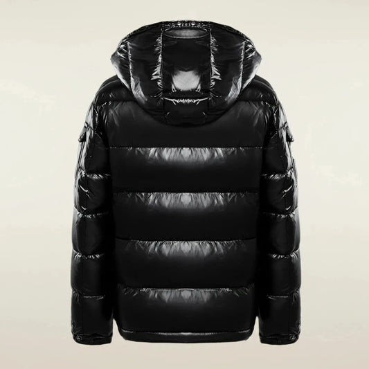 View of a stylish quilted winter puffer jacket in dark gray, featuring a high collar and adjustable hem