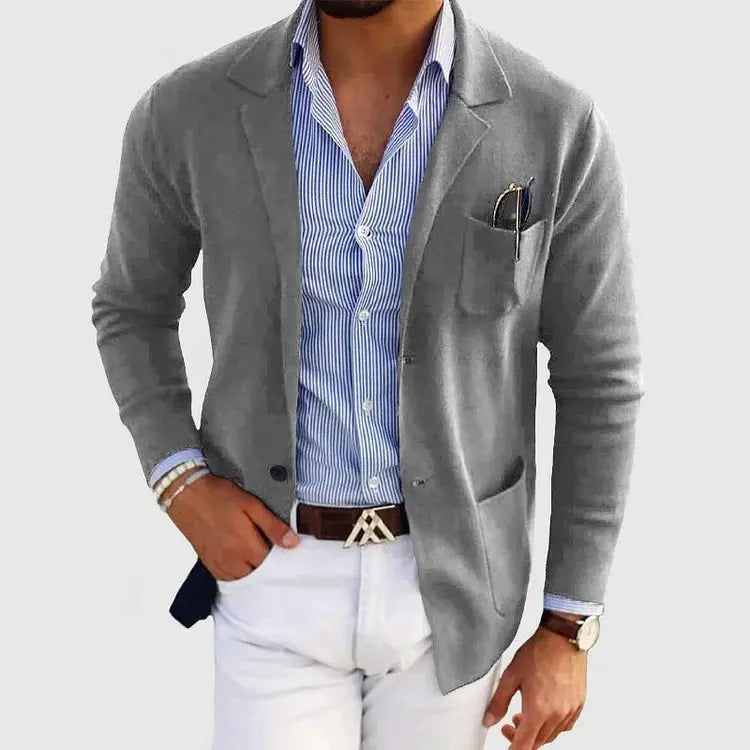 View of a polished relaxed blazer in deep charcoal gray, featuring a smooth fabric texture and tailored lapels