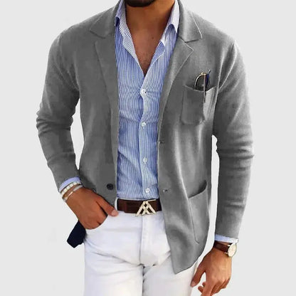 View of a polished relaxed blazer in deep charcoal gray, featuring a smooth fabric texture and tailored lapels
